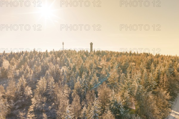 A bright winter sun over a snowy landscape with tower, Holohturm, Gernsbach, Rastatt district, Germany