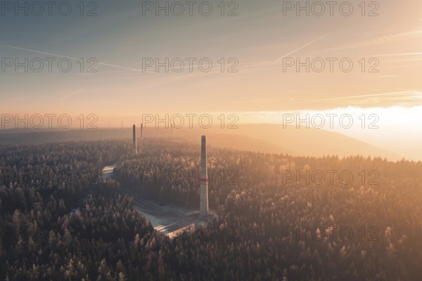 Dawn over a foggy forest with several wind turbine towers rising from the trees, Windkraft Bau, Besenfeld, Seewald, Freudenstadt district, Germany