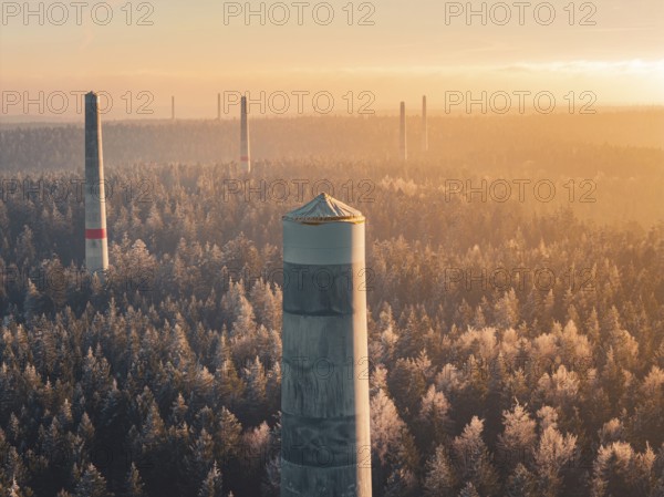 Wind turbine towers stand in orange light in the morning over a forest surrounded by thick fog, a mood of vast peace, Windkraft Bau, Besenfeld, Seewald, Freudenstadt district, Germany