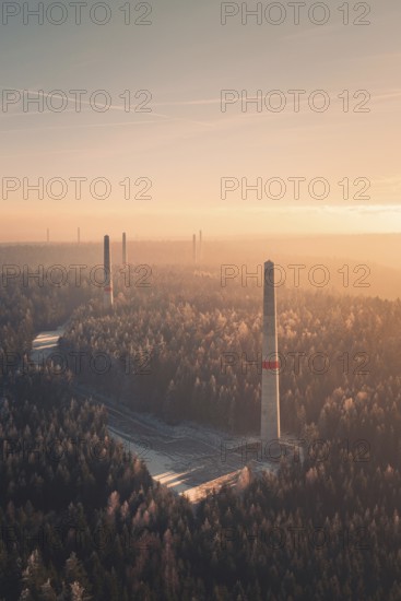 Wind turbine towers tower above a forest at sunset, soft pastel colors and fog create a quiet atmosphere, Windkraft Bau, Besenfeld, Seewald, Freudenstadt district, Germany