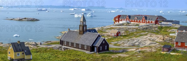 Typical architecture of Greenland Ilulissat with colored houses located near fjords and icebergs