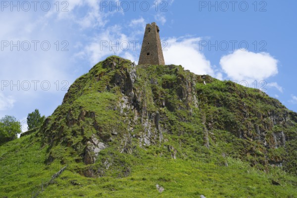 Historic tower ruin on a rocky hill under clear blue sky in nature, Zion Tower, Sioni, Georgian Military Road, Mtskheta-Mtianeti Province, High Caucasus, Georgia