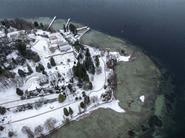 The wintry and snowy Mainau island in Lake Constance with the pier and the baroque Mainau Castle, built between 1739 and 1746, aerial view, district of Constance, Baden-Württemberg, Germany