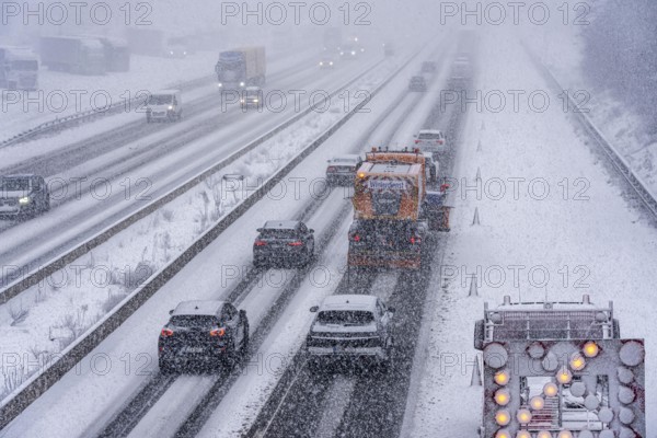 The onset of winter in North Rhine-Westphalia, heavy snowfall, A3 motorway near Hilden, near Ohligser Heide rest area, snow-covered roads, winter service of the motorway maintenance department with stray and clearing vehicles, traffic is sometimes only stalled, North Rhine-Westphalia, Germany