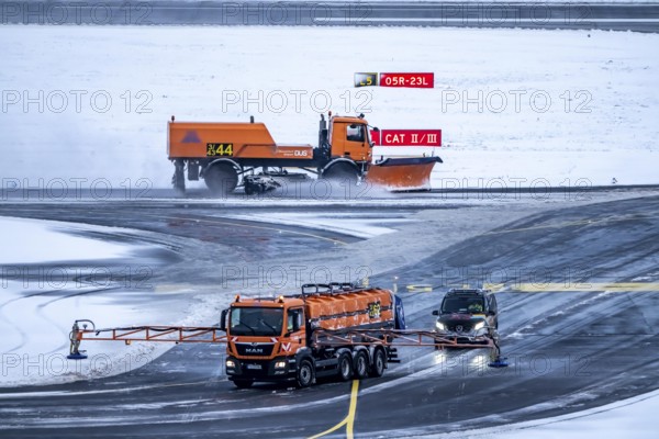 The onset of winter in North Rhine-Westphalia, flight operations are maintained at Düsseldorf Airport with great effort, the taxiways and runway are being freed from snow and ice with many clearing vehicles, North Rhine-Westphalia, Germany