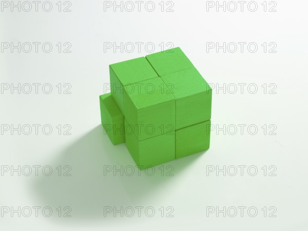 8 green wooden cubes against a white background