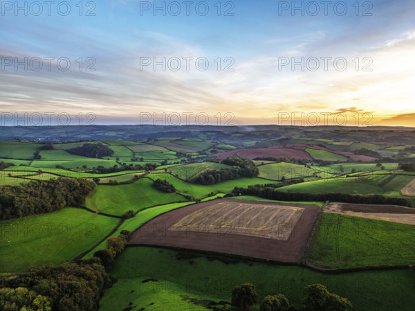 Sunset of Devon Farms and Fields over Berry Pomeroy from a drone, Totnes, England, United Kingdom