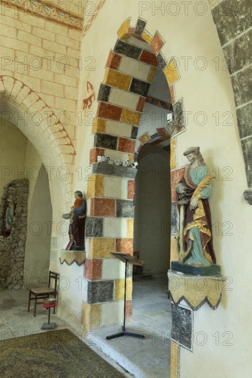 Painted arch in red, yellow and black. St Aignan's Church of Begues. Allier department. Auvergne Rhone Alpes. France. Europe