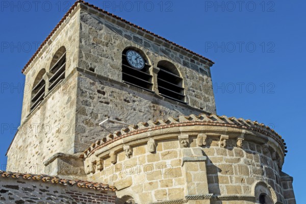 Issoire. Pillar (The Annunciation made to Mary) . The figures are illuminated by colorful light shining through a stained glass window inside Saint Austremoine Abbey, Puy de Dome, Auvergne Rhone Alpes, France