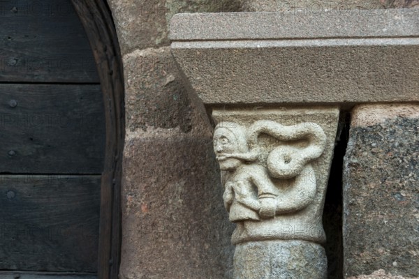 Sculptural details on the porch of the Romanesque church in Azerat village, Haute Loire, Auvergne-Rhone-Alpes, France
