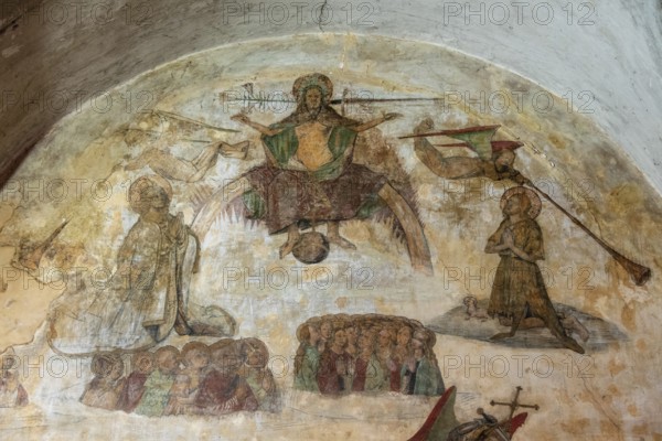 Issoire. Pillar (The Annunciation made to Mary) . The figures are illuminated by colorful light shining through a stained glass window inside Saint Austremoine Abbey, Puy de Dome, Auvergne Rhone Alpes, France