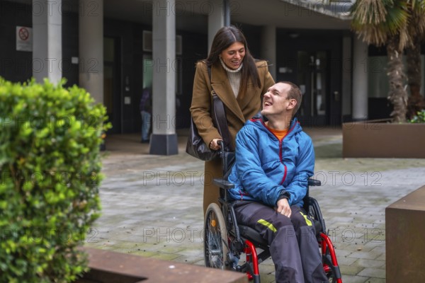 Woman and man with disability smiling outdoors, focusing on happy interaction, personal growth, empowerment, and social inclusion within a supportive and caring community