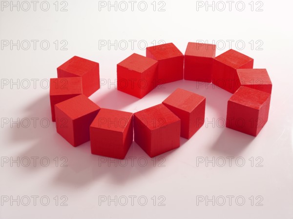 12 red wooden cubes against a white background