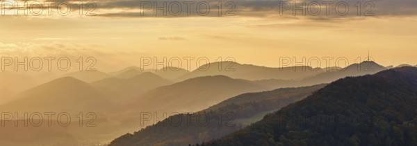 View of an autumnal forest from the Gisliflue, behind the Jurassic foothills with the water fluh in the light of the setting sun, Talheim, Canton, Aargau, Switzerland