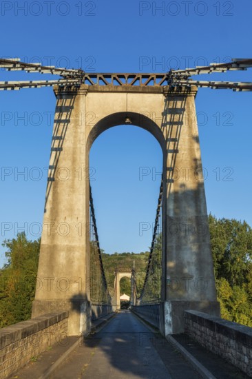 Suspension bridge of Coudes village on river Allier. Puy de Dome. Auvergne Rhone Alpes. France