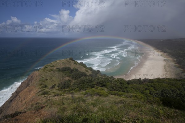 Tallow Beach bay with rainbow, lookout Byron Bay lighthouse, New South Wales, Australia