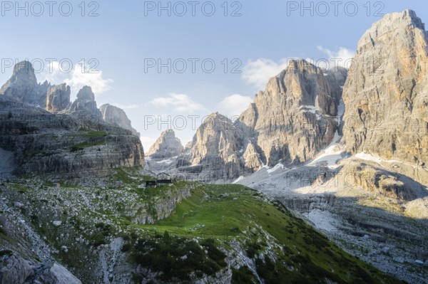 Picturesque mountain landscape in the morning, Rifugio Ai Brentei mountain hut and Cima Tosa rock peak, Brenta, Trentino, Italy