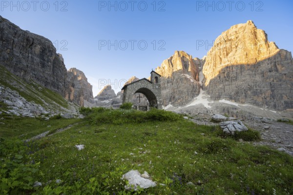 Cappella Ai Brentei chapel Memorial for injured mountaineers at the Rifugio Ai Brentei mountain hut, rocky peaks at sunrise with alpine glow, picturesque mountain landscape, Brenta, Trentino, Italy
