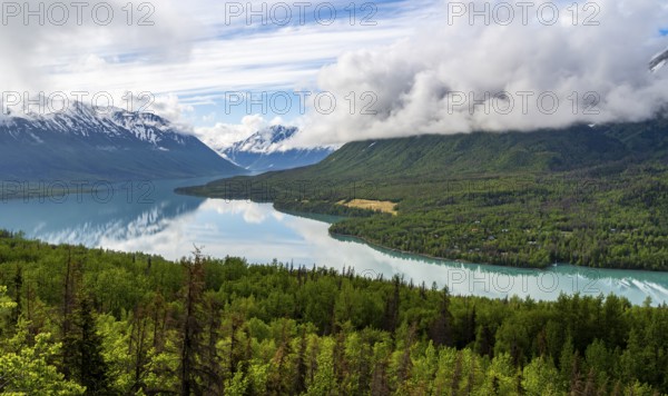 View of snowy mountains in spring and turquoise blue Kenai Lake, Slaughter Ridge Trail, Cooper Landing, Kenai Peninsula, Alaska, USA
