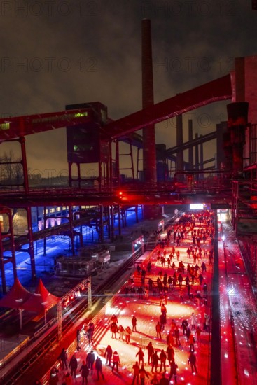 Ice rink at the Zollverein coking plant, ice skating with music and many lighting effects, Essen, North Rhine-Westphalia, Germany