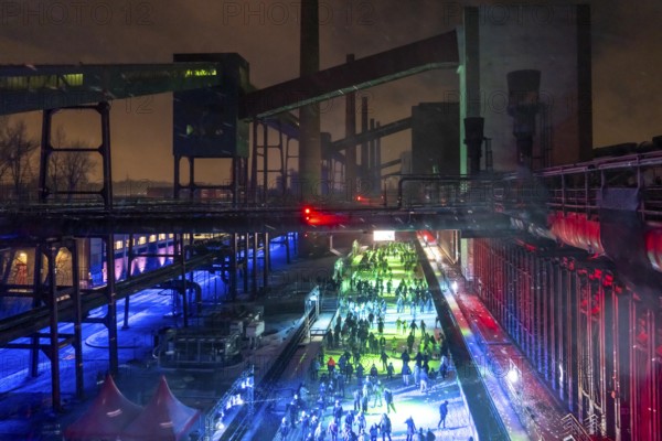 Ice rink at the Zollverein coking plant, ice skating with music and many lighting effects, Essen, North Rhine-Westphalia, Germany