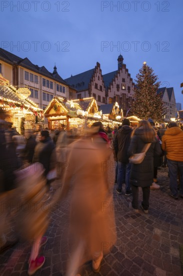 December 22, 2025, Frankfurt Christmas Market on Roemerberg at twilight. Traditional wooden stalls and festive lights shine in the historic square, Frankfurt, Hesse, Germany