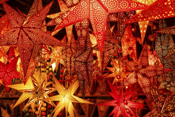 December 22, 2025, many glowing Christmas stars hanging at a market stall near St. Paul's Church, Frankfurt, Hesse, Germany