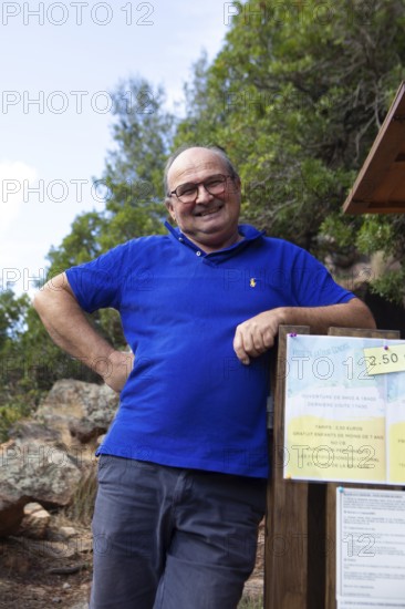 Corsican man, 67 years old, checks the entrance to the Genoese Tower of Porto, Ota, west coast of Corsica, Corse-du-Sud, Corsica, France
