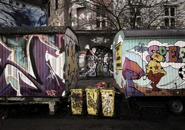 Kiefernstraße, residential street of the left-wing alternative scene with street art and construction trailer in the morning, Düsseldorf, North Rhine-Westphalia, Germany