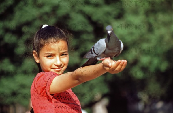 Girl lets dove eat out of her hand, Placa de Catalunya, Barcelona, Spain, June 1999, vintage, retro, old, historic