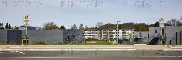 School bus stop, Hauptschule Mathilde - Anneke - school, houses, modern buildings, apartment buildings, residential buildings, lantern, trees, meadow, diffuse light, milky blue sky, cirrostratus clouds, Dresdener Straße, Sprockhövel, Ennepe-Ruhr-Kreis, North Rhine-Westphalia, Germany