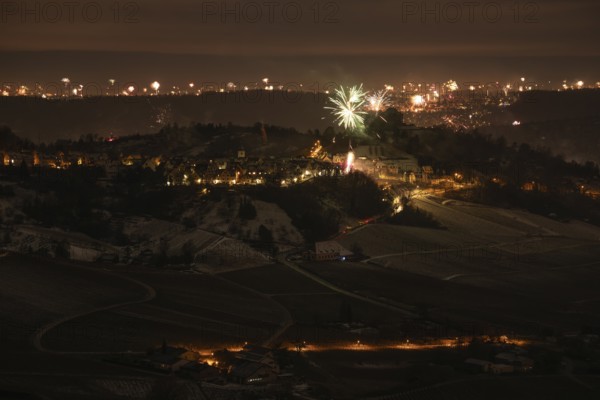 New Year's Eve view from Kapellberg near Fellbach towards Rotenberg. View of the grave chapel in Württemberg as fireworks rockets and firecrackers illuminate the night sky over Stuttgart on New Year's Eve from 2025 on 2026 at the turn of the year