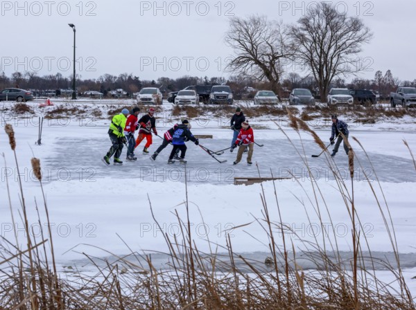 Detroit, Michigan USA - 1 January 2026 - As temperatures dropped and snow fell in the Great Lakes region, people shoveled ice off Lake Okonoka in Belle Isle State Park to play ice hockey on New Year's Day