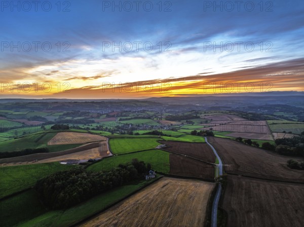 Sunset of Devon Farms and Fields over Berry Pomeroy from a drone, Totnes, England, United Kingdom