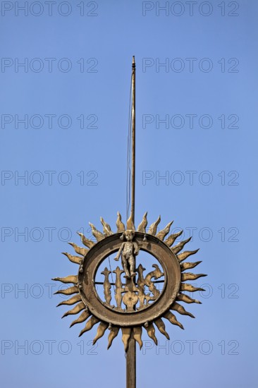 Metal sculpture with sun motif against clear blue sky, reliefs at the Basilica of St. Francis in Lima in Peru