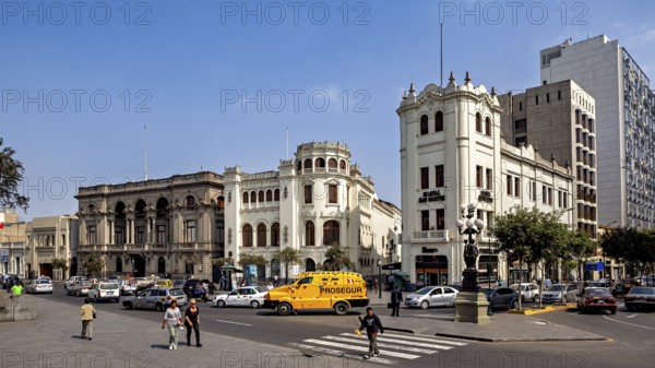 Distinctive historic buildings at a busy crossroads under blue skies, Downtown Lima in Peru