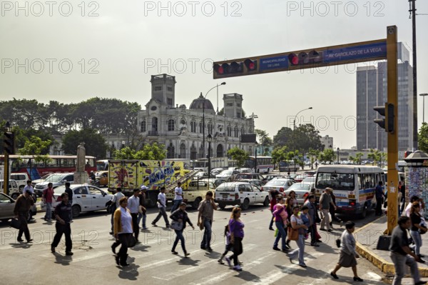 Urban street scene with pedestrians and traffic in front of historic buildings, Downtown Lima in Peru