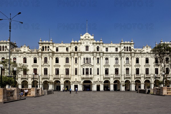 Large historic building in an open square with bright blue sky, Downtown Lima in Peru
