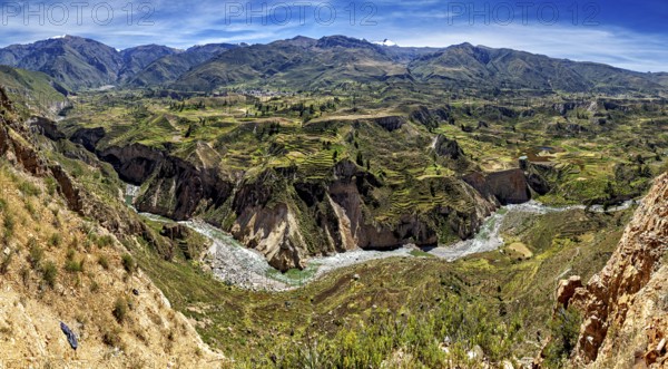 Panorama of a mountain landscape with terraced fields and a river, The landscape of the Colca Canyon in the Andes of Peru