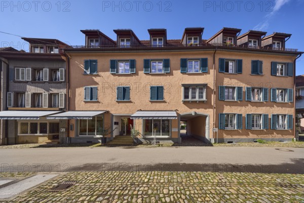 Row of houses, historic buildings, residential buildings, dormers, façade with windows, shutters and awnings, shop window, optician wedge glasses contact lenses, road made of asphalt and cobblestones, blue sky, cumulus clouds, Kirchstraße, Staufen im Breisgau, Black Forest, Breisgau-Hochschwarzwald district, Baden-Württemberg, Germany