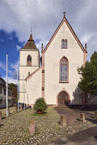 St. Martin parish church, neo-Gothic style, church tower, church tower clock, flagpoles, barrier bollards, entrance door, church window, trees, blue sky, cumulus clouds, Kirchstraße street, Staufen im Breisgau, Black Forest, Breisgau-Hochschwarzwald district, Baden-Württemberg, Germany