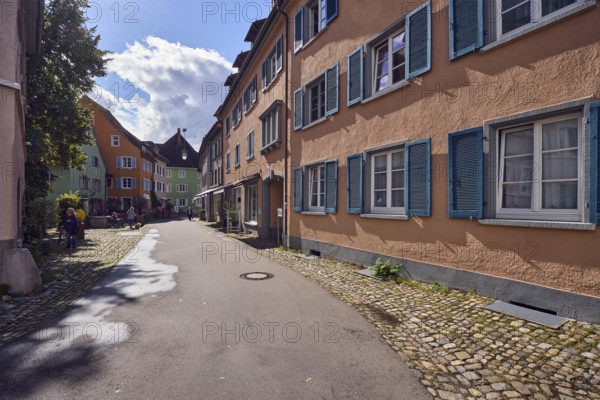 Historic residential and commercial buildings, apartment building, general architecture, façade with windows, shutters and awnings, shopping, trees, pedestrians as accessories, back light, blue sky, cumulus clouds, Kirchstraße street, Staufen im Breisgau, Black Forest, Breisgau-Hochschwarzwald district, Baden-Württemberg, Germany