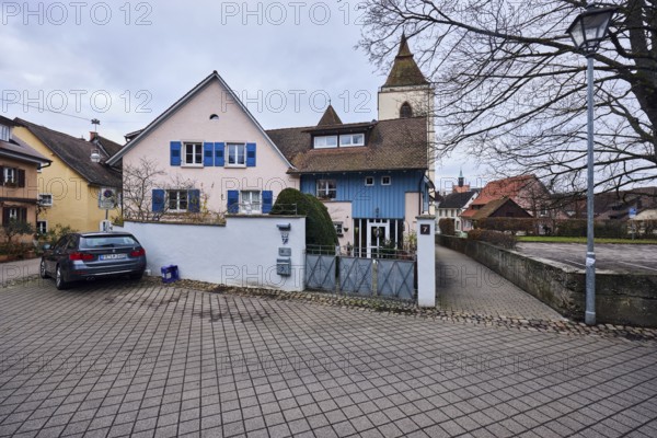 St. Martin church tower, general architecture, houses, residential buildings, multi-family house, lantern, car, cloudy, diffuse light, St.-Johannesgasse, Staufen im Breisgau, Black Forest, Breisgau-Hochschwarzwald district, Baden-Württemberg, Germany