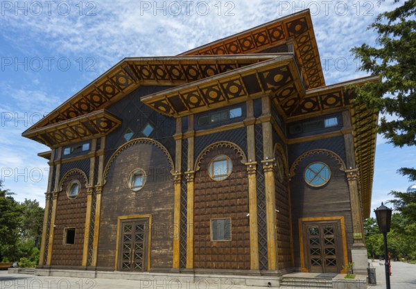 A distinctive wooden building with artistic decorations against a tranquil backdrop, Summer Theatre, Batumi, Black Sea, Ajara region, Adjara, Autonomous Republic, Georgia