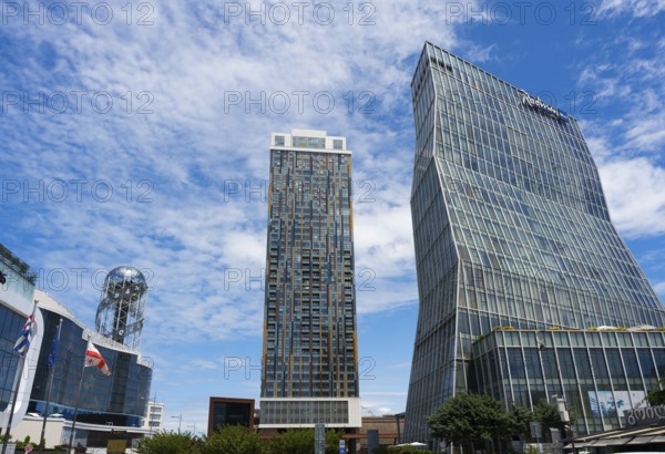 Two modern high-rise buildings with glass facades under cloudy sky, Radison Blue on the right and Alphabetic Tower, Georgian Alphabet Tower, Batumi, Black Sea, Adjara region, Adjara, autonomous republic, Georgia