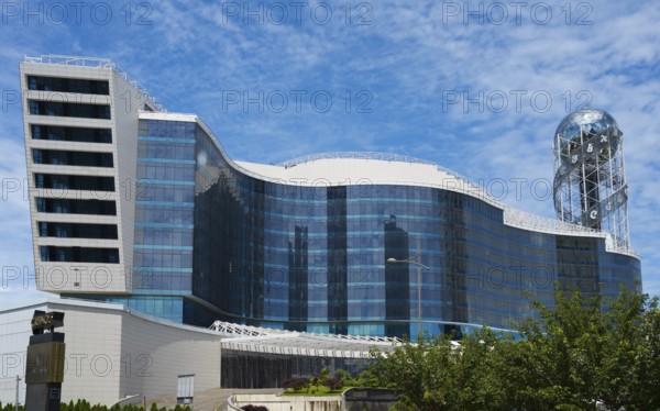 Modern building with wave-like design and glass façade under blue sky, business loft, right Alphabetic Tower, Georgian Alphabet Tower, Batumi, Black Sea, Adjara region, Adjara, Autonomous Republic, Georgia