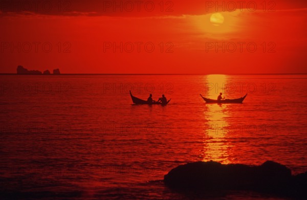 Fishing boats at sunset, silhouettes, orange filter, Ko Lanta island, Thailand, December 2002, vintage, retro, old, historic