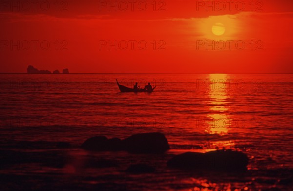 Fishing boat at sunset, silhouettes, orange filter, Ko Lanta island, Thailand, December 2002, vintage, retro, old, historic