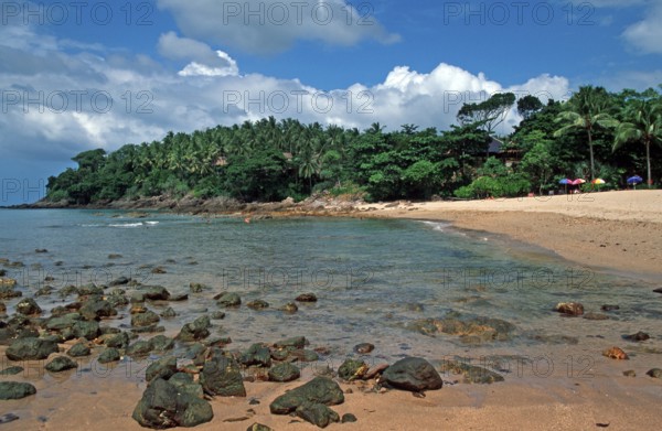 Palm trees, umbrellas, beach at Coral Beach Resort on the island of Ko Lanta, Thailand, December 2002, vintage, retro, old, historic