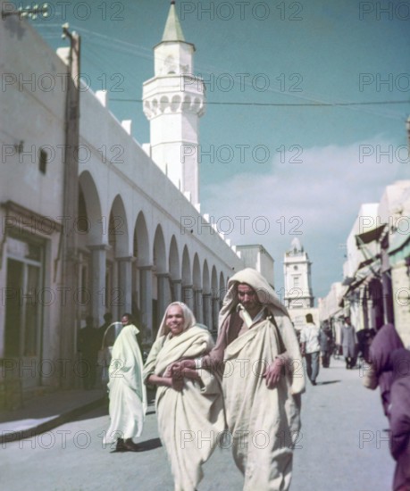 Leading blind person in street, Tripoli, Libya, North Africa 1956 minaret of Ahmed Pasha Karamanli Mosque, Al-Mushir Mosque or the Pasha Mosque